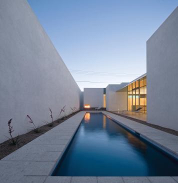 The house's side courtyard is shielded from view by the building and a high garden wall.