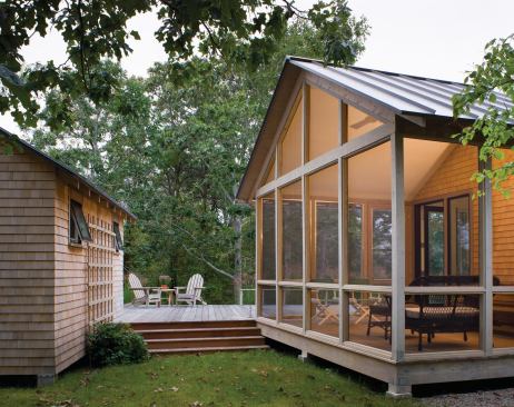 A screened porch at the rear of the main house provides a semi-outdoor option.