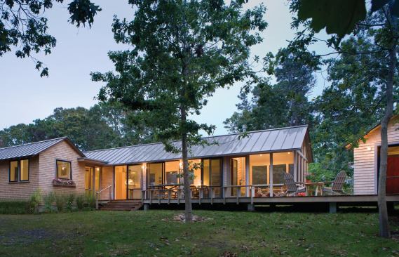 The 1,344-square-foot house is topped with a standing seam metal roof and clad in simple, white cedar shingles.