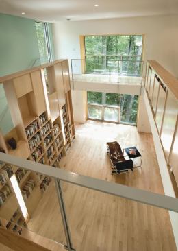 The tower is a four-story structure with a two-story library on top and a master suite below. The lower level of the library has access to the wrap-around deck.
