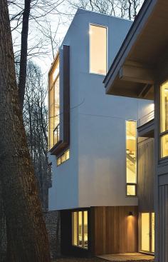 The tower has commercial windows in different shapes and sizes, which provide a connection to the outdoors and provide the owners with differing views of the landscape as they walk up and down.
