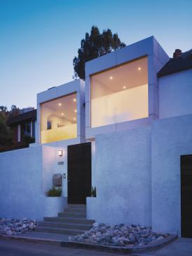 This 1940s house had been renovated several times, which resulted in a mishmash of styles. The homeowners had lived in the house for eight years and considered moving, but liked their existing location. They approached Griffin Enright Architects, in Los Angeles, for an open, modern renovation. The designers replaced the two existing bay windows with glass-front cubes encased in concrete board.