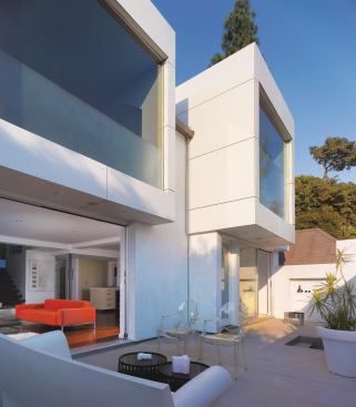 To combine the courtyard sections into a single cohesive space, architect Margaret Griffin removed a center wall. Telescoping doors in the living room help extend the living space into the courtyard, with an easy flow from the living room to the dining room to the fire pit.