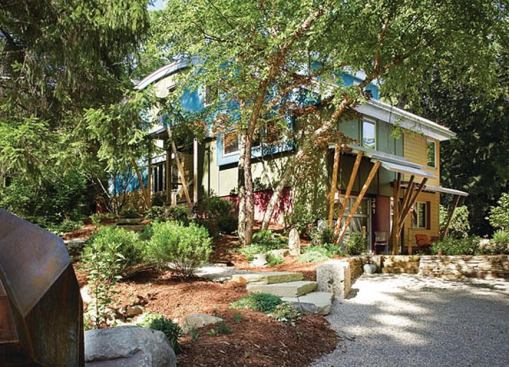 The owner wanted the home to be a harbinger of innovative green design and construction. Although the designer did not add much to the footprint, he radically changed the home from its colonial-style beginnings. Flexible spaces make the small home appear larger.