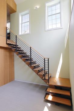 The most important architectural decisions were subtractive, the designer says. Here, Eisner removed a portion of the first floor to create a double-height atrium space. The new stairwell connects the main living floor with the basement level, which now receives ample natural light.
