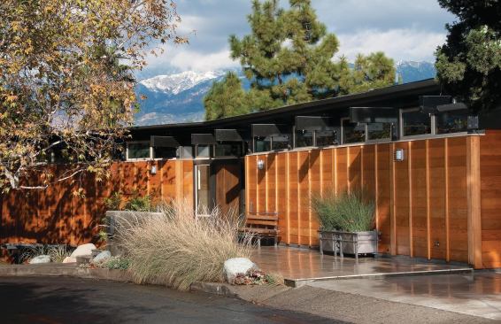 To maintain street-front privacy, the entry elevation has high clerestory windows set above walls clad in red cedar. The custom entry door is made of Honduran mahogany.