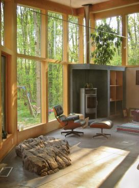 In one of the new wings, an open living room connects to the kitchen and outdoor areas.