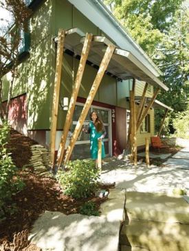 Form meets function in this awning  a moveable piece of art that is one of the first things guests see when they come up the homes gravel driveway. The design involved a telescoping nesting array of curved metal roof segments supported on metal frames and attached to articulating structural posts. 