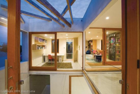 The wood beams that span the small open courtyard were reused from the existing house.