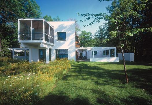The outdoor rooms are framed with white-stained wood and screened with 2x2 slats.