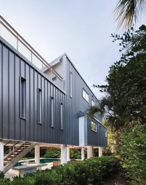 Standing-seam metal, a common local roofing material, shields the rear facade.
