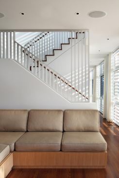 On the southwest-facing facade, wood louvers play with sun and shadow.