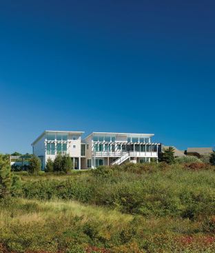 Custom, stainless steel railings grace both the exterior and the interior of the Cooperstein House in Truro, Mass.