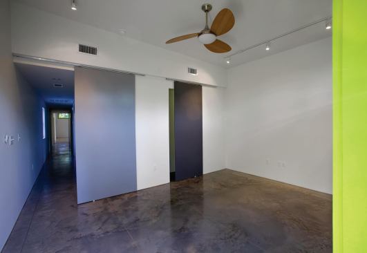 The master bedroom. High ceilings and concrete floors facilitate passive cooling.

