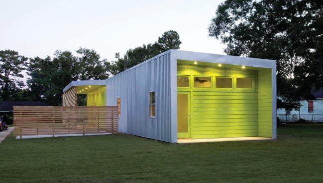 The master bedroom opens onto a private rear porch. High windows provide natural ventilation while protecting privacy.