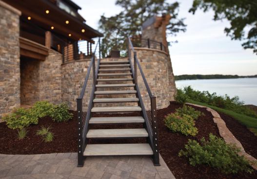 Steel railings bracket the floating bluestone-slab stairway.