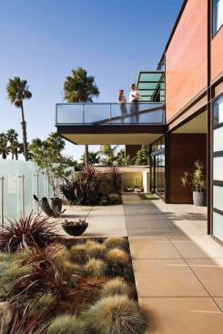A cantilevered deck juts out to shade the entry patio.
