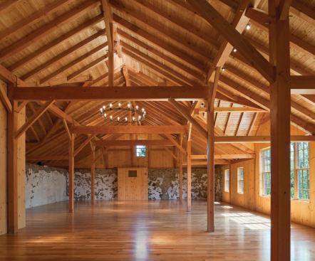 A reception hall with a new post-and-beam frame provides a space for hosting weddings, parties, and corporate events.