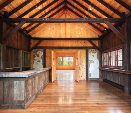 Peter Zimmerman Architects and builder Ed Mahoney used wood salvaged from the original siding in the renovated wine-tasting room.