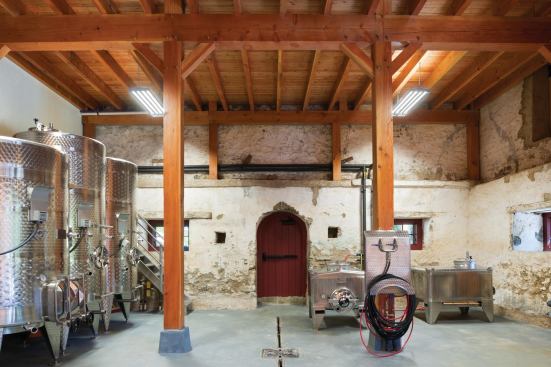 A winemaking facility lies within the old stone walls on the barn's lower level.