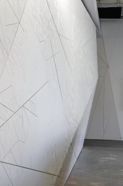 Behind the reception desk, CNC-milled MDF wall panels were cut from a pinwheel aperiodic tiling pattern.