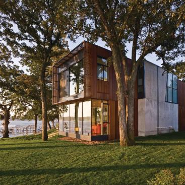 The Lake Okoboji house creates a set of blinders on a narrow lot in rural Iowa, screening close neighbors while gradually opening to lake views.