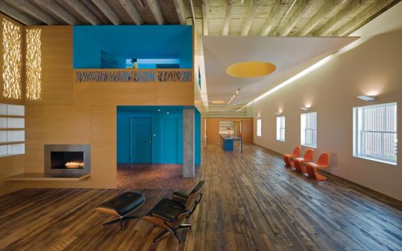 In this penthouse overlooking downtown Omaha, Neb., CNC-cut railing and light filters suggest prairie grasses.