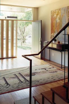 Custom metal detailing, such as a slim, graceful stair railing, pulls the home together.