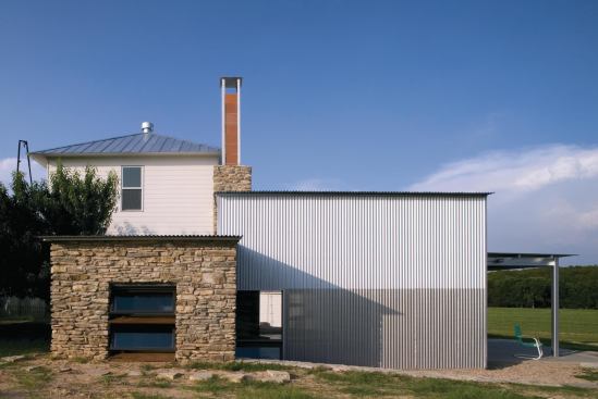 At a guest house and "party barn" Hico, Texas, industrial materials such as PVC and perforated aluminum...