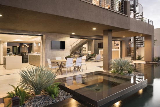 Desert Oasis The line between indoors and out is blurred by several clever design tricks. Sierra Pacific sliding pocket doors recede into the walls to create doorways up to 26 feet wide, and Walker Zanger flooring extends from interior rooms to the courtyard, up to the edge of the pool. “The materials we’ve used tie the spaces together,” Miquel Hutton says. “The idea &nbsp;is to draw people out to those areas using those materials to make it look seamless.”