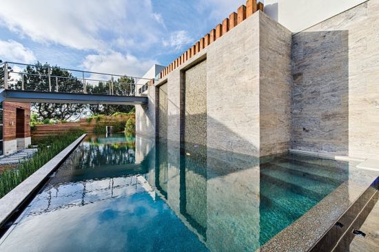 Up and Down: A window was placed at the bottom of the pool to provide a visually interesting skylight to the basement of the home.