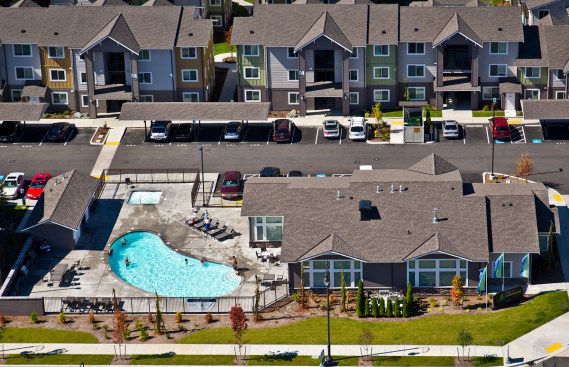 Residents choose between surface parking, carports, and 90 detached rental garages. The basketball court sports the local high school colors.