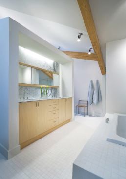 The master bathroom features custom maple cabinets and a large soaking tub.