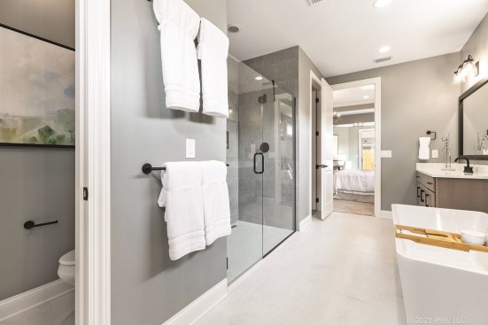 A zero-threshold shower and lever door handles help provide easy access in this bathroom by Epcon Communities.