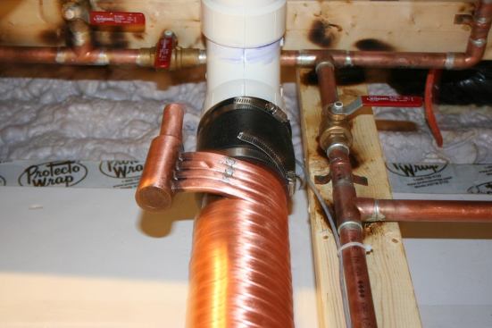 A coil around the shower drain pipe recovers heat to help warm incoming shower water.