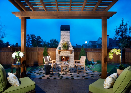 Low-maintenance, garden-style homes in the builder’s sold-out, gated Woodbridge Crossing community in Selma, Ga., come with professionally landscaped yards that the homeowner’s association maintains. Homeowners could opt for outdoor features like this brick fireplace in the home’s private side courtyard.