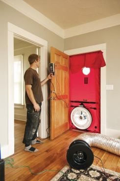 Staffer Andrew Morphis performs a blower door test on a renovation designed and built by Green Hammer for the owner of the local woodworking shop The Joinery.