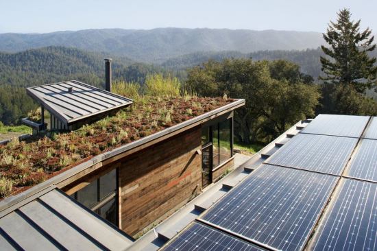 The home includes a vegetated rood, photovoltaic panels, reclaimed lumber, and many additional salvaged and non-toxic materials.