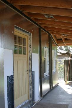 Extra Protection. A door entrance is embedded into a wall sheathed with 3/4-inch rigid insulation board.