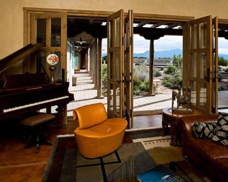The sitting room provides sweeping panoramic views of the Ortiz Mountains. The surrounding yard features native, drought-tolerant landscaping irrigated with a drip system using stormwater and blackwater. 