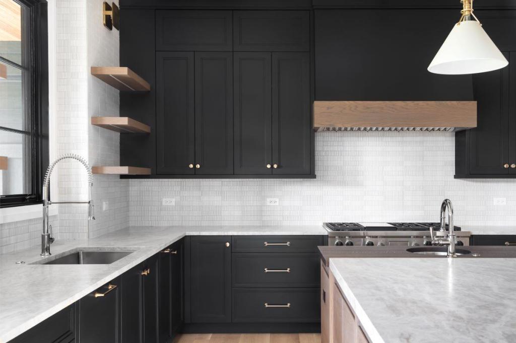 Warm woods and mixed metals add interest in this contrasting black and white kitchen.